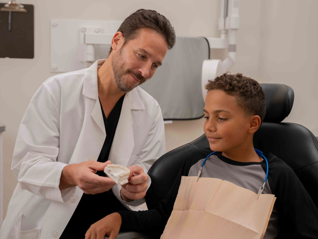 male dentist and young boy patient