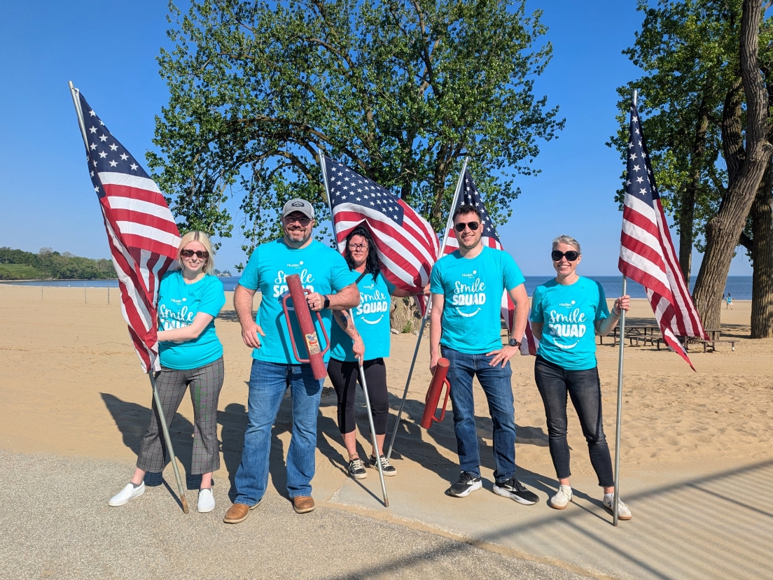 The Hudec Dental team posing for a group photo at the Edgewater Park Memorial Day Flag Display